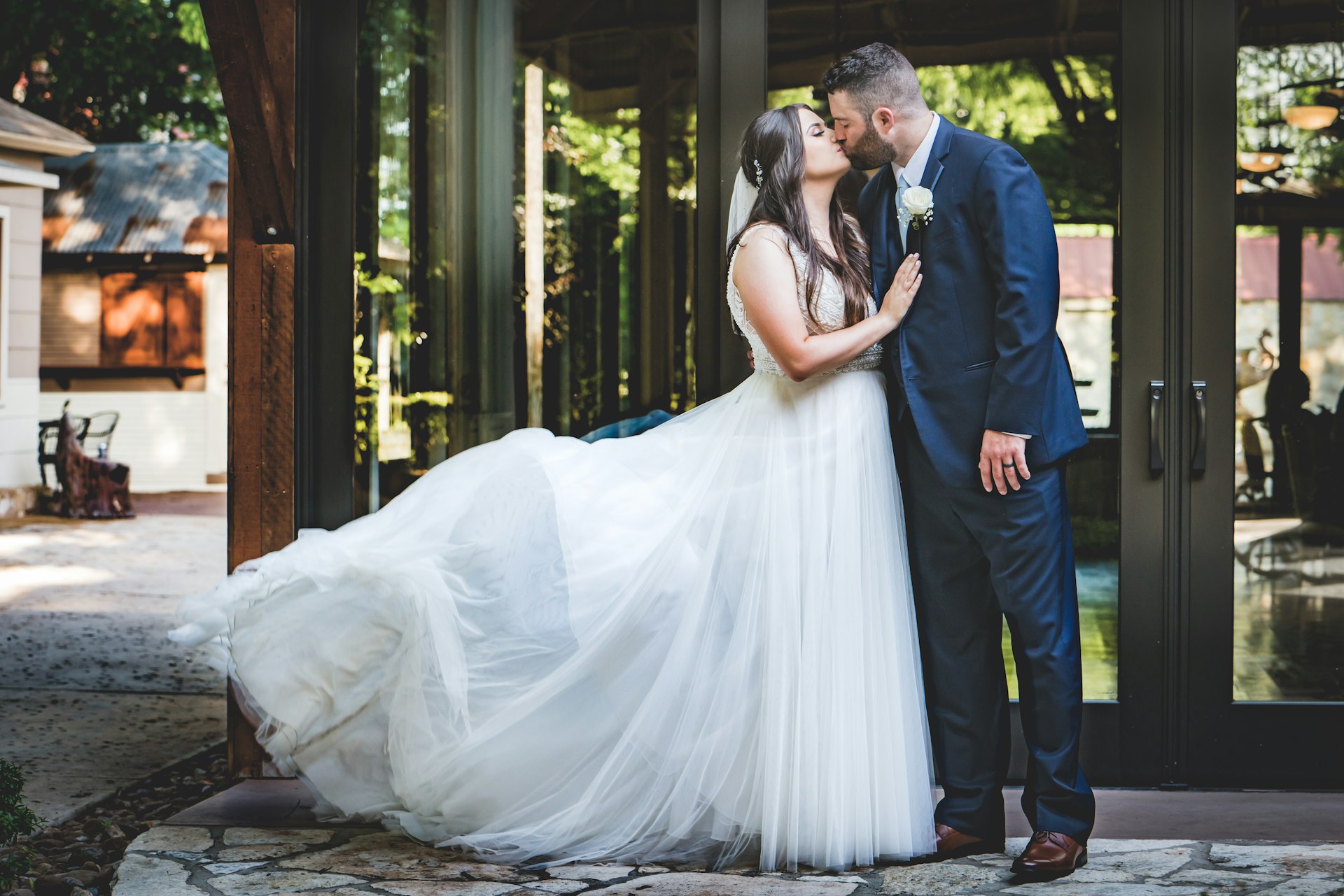 bride and groom standing on brown wooden floor